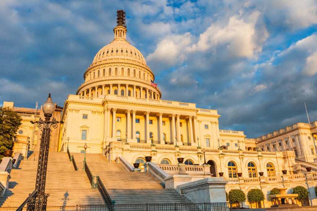 US Capitol illuminated by sunset sun