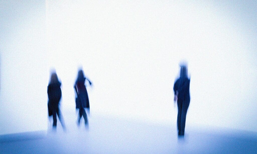 Blurry image of three silhouettes