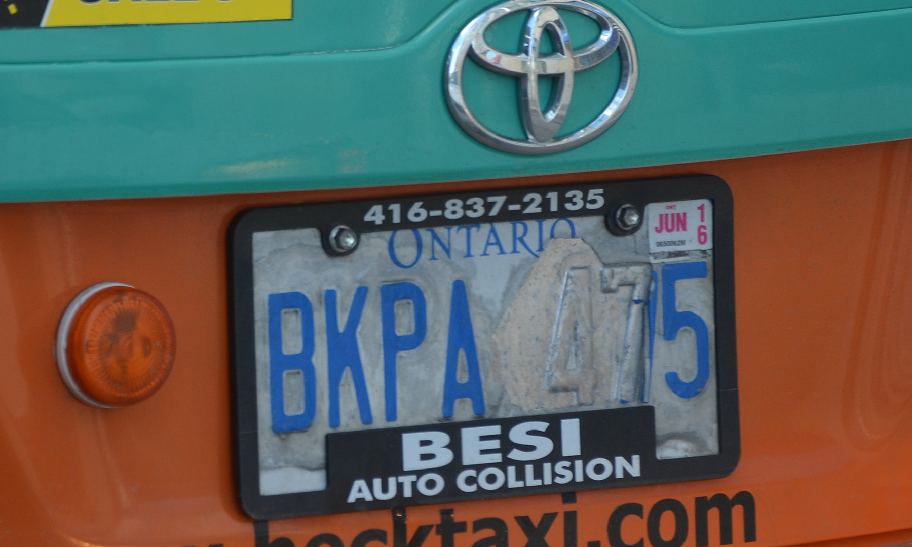 Ontario licence plate on a yellow and teal trunk