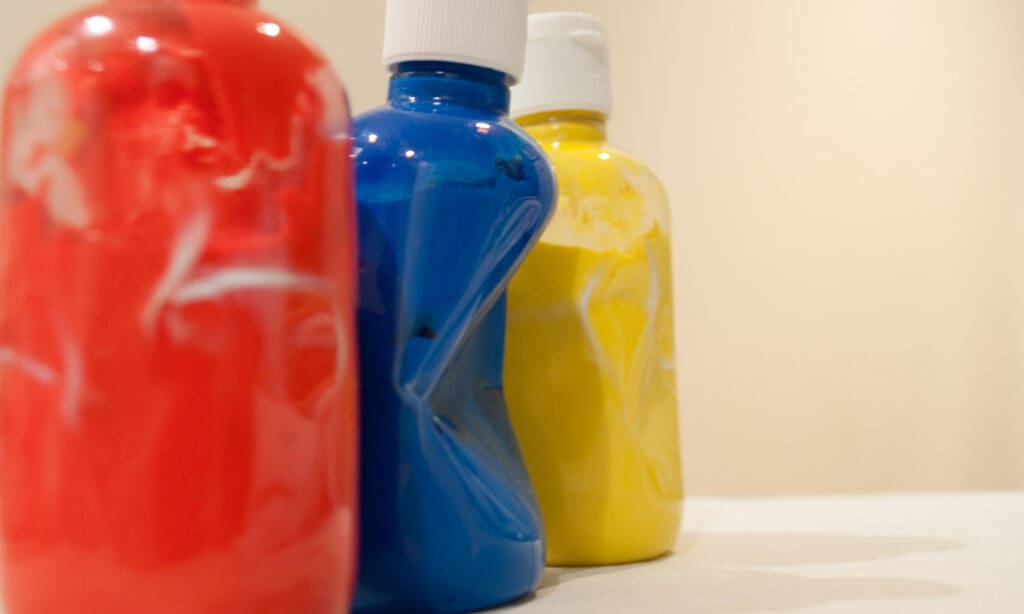 Three bottles of paint red blue and yellow