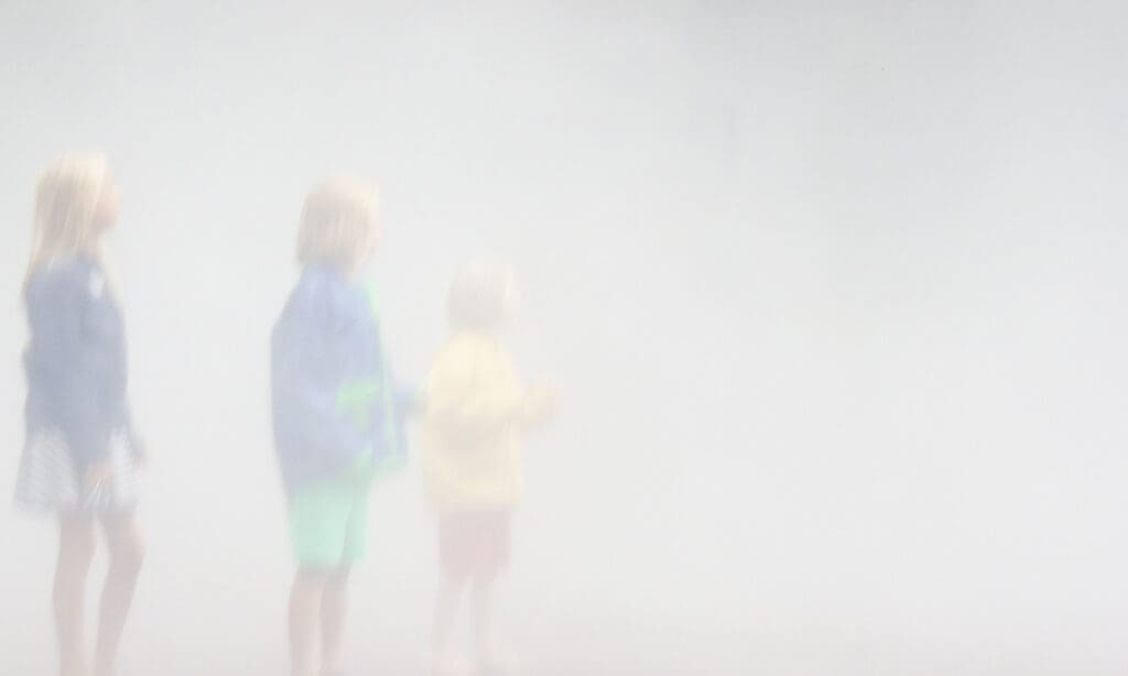 Three children in blurry weather