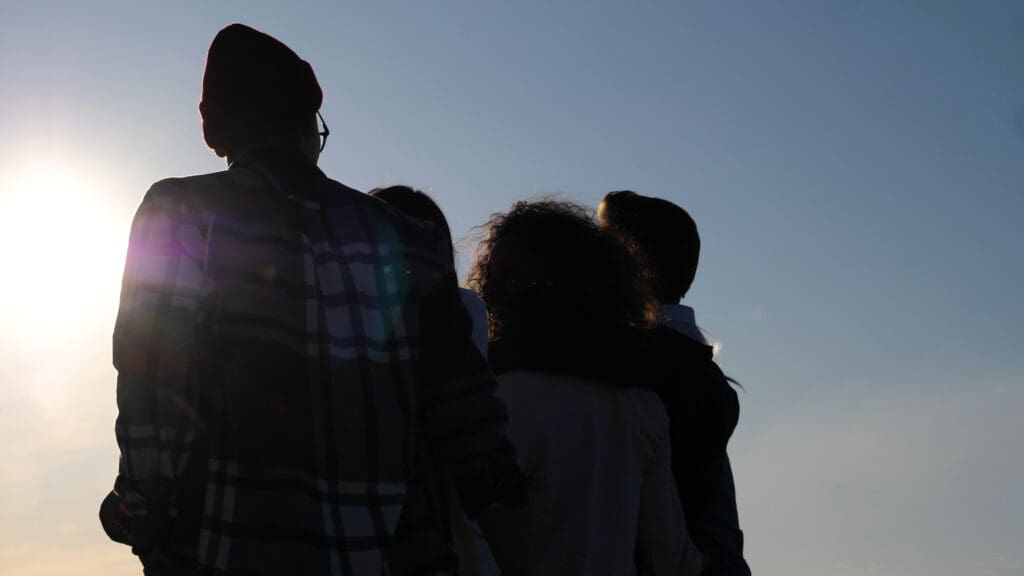 Silhouette Group of Happy Teenagers Walking in the sun