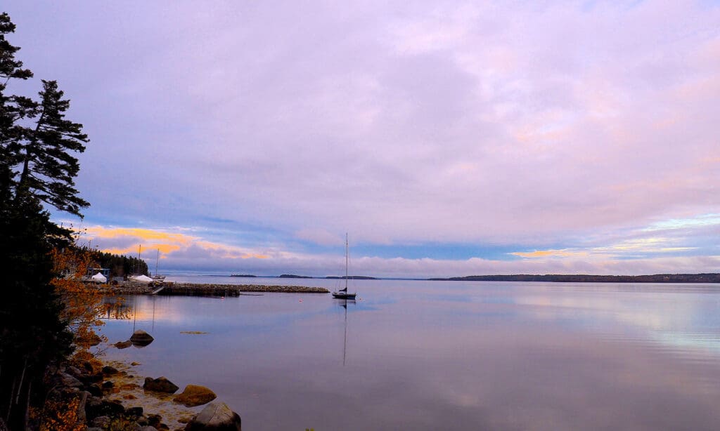 boat near the coast line on calm waters