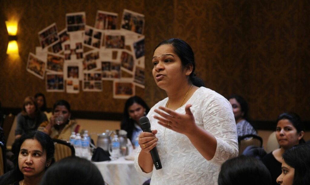 Woman standing and speaking passionately to crowd