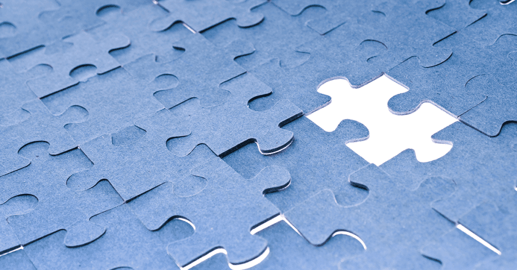 close of a blue puzzle with a missing piece