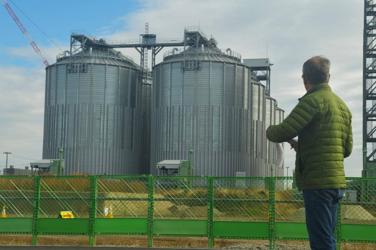Ben Parfitt outside a new pellet-burning thermal electricity plant in Sendai. The giant silos willl hold wood pellets imported from Canada and elsewhere. Photo: Conservation North.