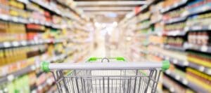 Photo of shopping cart in a grocery store as a part of rising cost of living article.