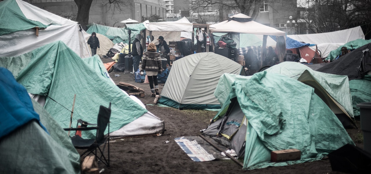 Tent city in Victoria, 2016. by <a target="_blank" href="https://www.flickr.com/photos/mgabelmann/">Michael Gabelmann</a> / Flickr” style=”border-radius:0px;–objectFit:cover;–imagePosX:50%;–imagePosY:50%” decoding=”async” srcset=”https://www.policyalternatives.ca/wp-content/uploads/2025/04/pn_feb2019_FiveNewInvestments_feature.jpg 1280w, https://www.policyalternatives.ca/wp-content/uploads/2025/04/pn_feb2019_FiveNewInvestments_feature-300×141.jpg 300w, https://www.policyalternatives.ca/wp-content/uploads/2025/04/pn_feb2019_FiveNewInvestments_feature-1024×480.jpg 1024w, https://www.policyalternatives.ca/wp-content/uploads/2025/04/pn_feb2019_FiveNewInvestments_feature-768×360.jpg 768w” sizes=”(max-width: 1280px) 100vw, 1280px” /></a><div  class=