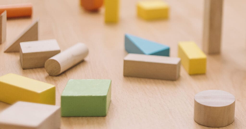 colorful wooden building blocks in the floor at home or kindergarten, educational toys for creative children