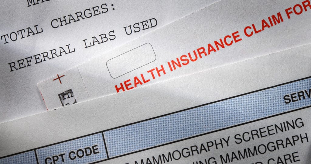 A health insurance claim form along with a couple of medical bills.To see more of my medical images click on the link below