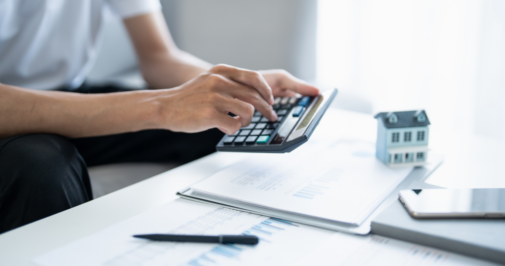 A person doing calculations on a calculator