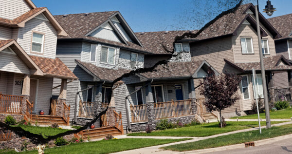 Houses in suburban Saskatoon are broken down the middle by a large crack