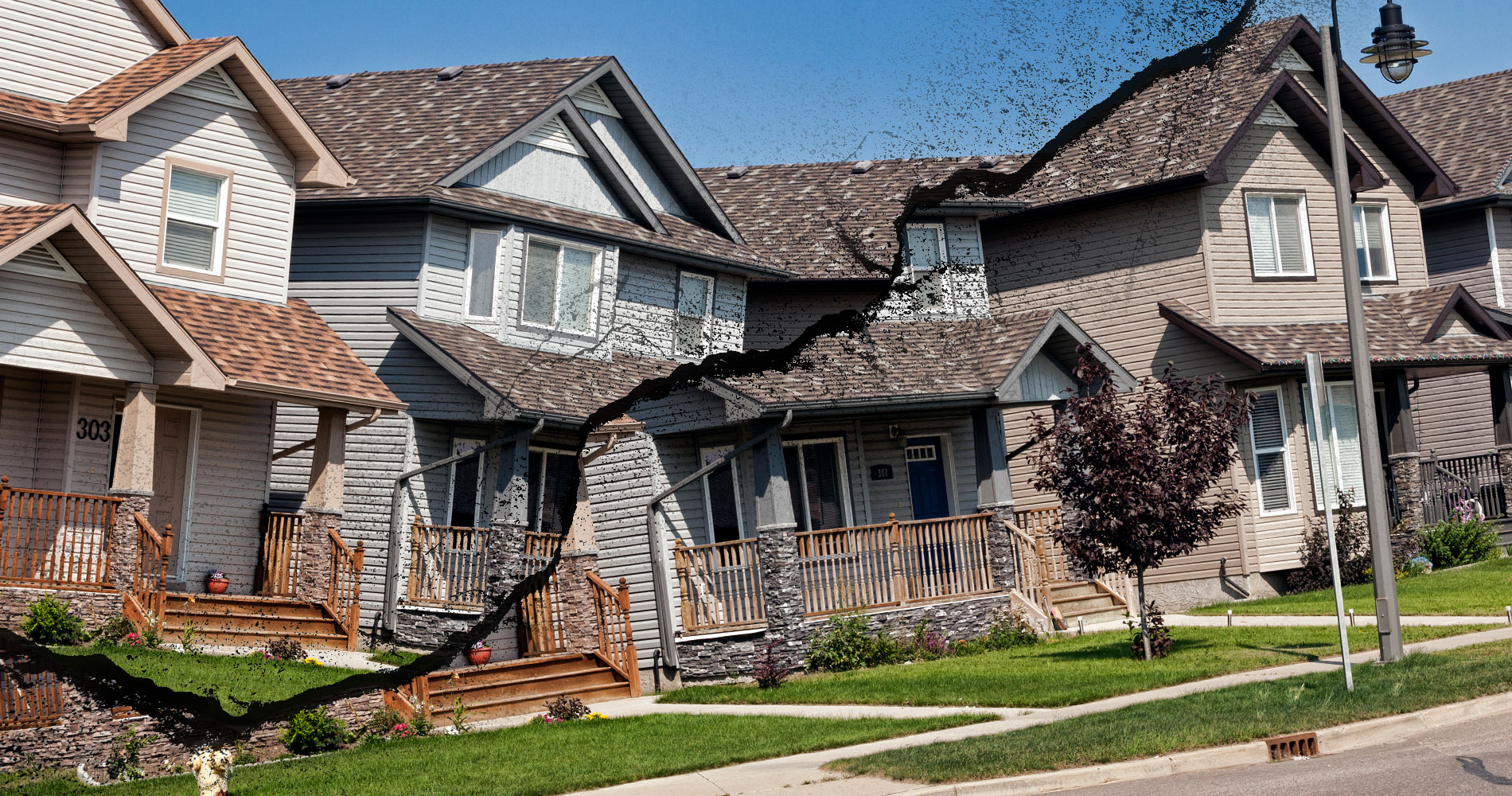 Houses in suburban Saskatoon are broken down the middle by a large crack