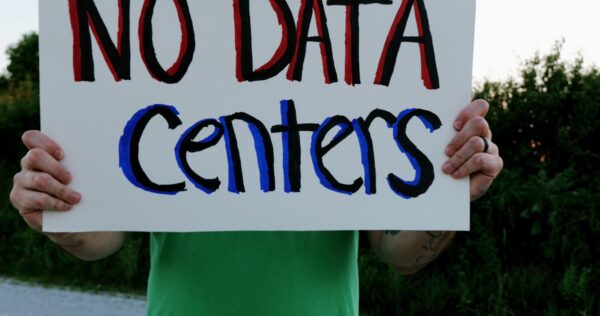 Someone holding a sign saying No Data Centers