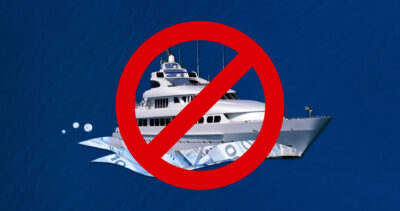 A luxury yacht with a large red slashed circle around it